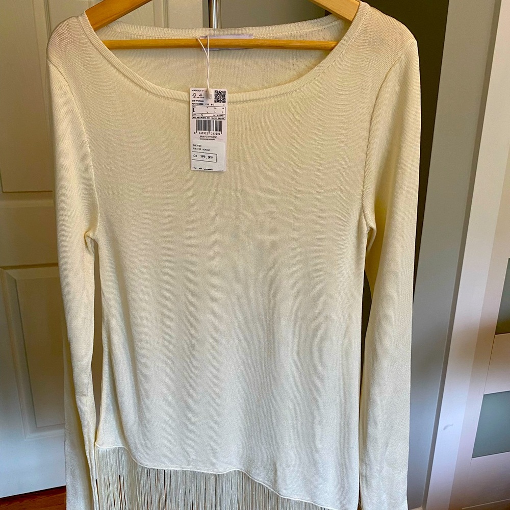 Mango size large ivory sweater with angled fringe bottom.